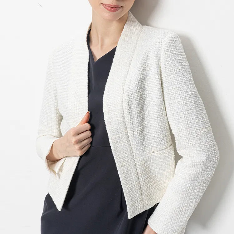 A refined tweed bolero jacket that drapes with effortless luxury