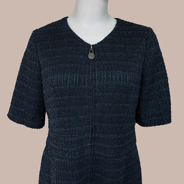 A sleek neckline with a collarless design that exudes refined elegance